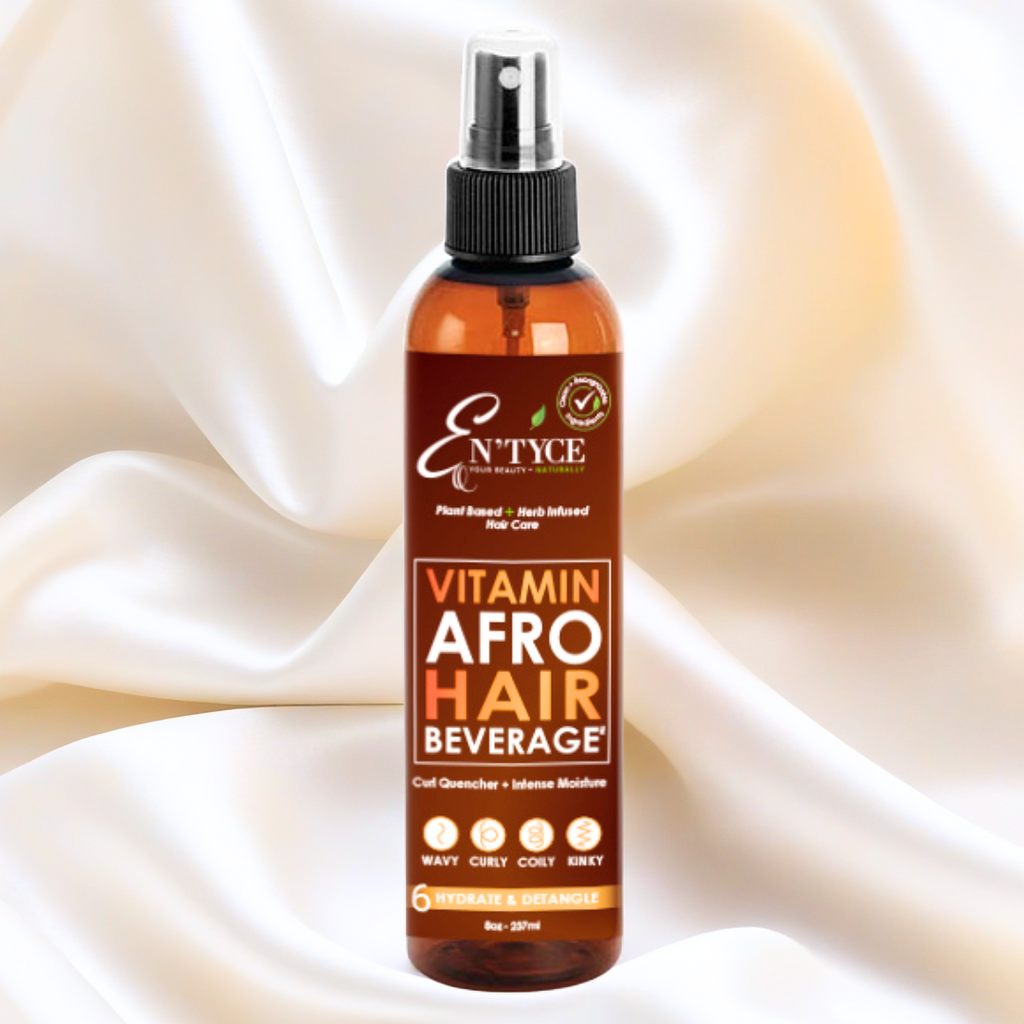 Bottle of En'tyce Vita(min) Afro Hair Beverage on a beige fabric background