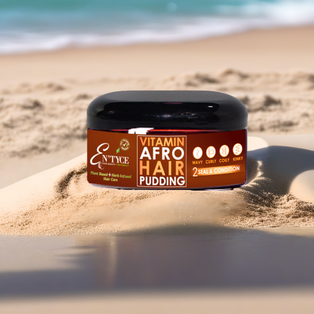 En'Yce Vitamin Afro Hair Pudding jar on a sandy beach with ocean waves in the background