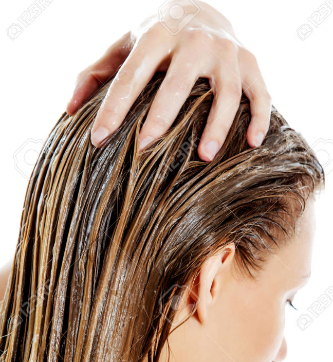 Person with wet hair being held by a hand on a white background