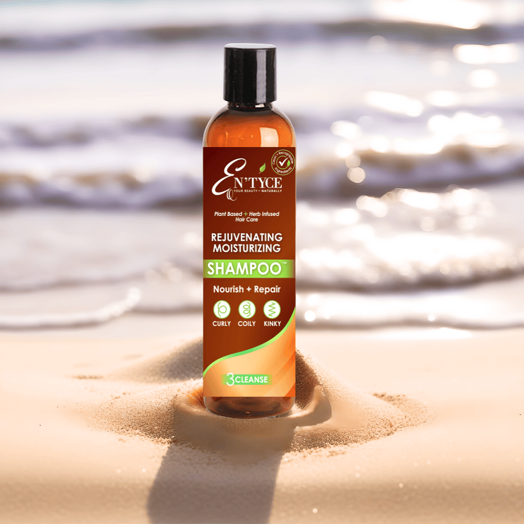 En'tyce shampoo bottle on sand with water in the background