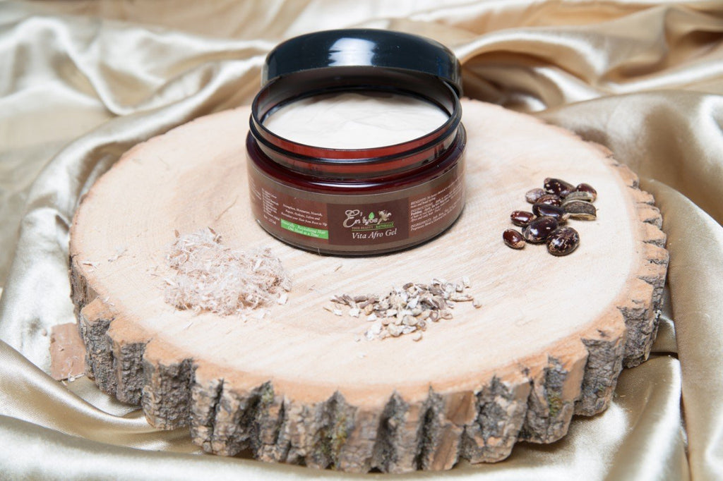 Vita(min) Afro Curl Defining Gel handmade plant-based herb-infused medicinal luxury hair care - open jar image with herbs on wooden plank